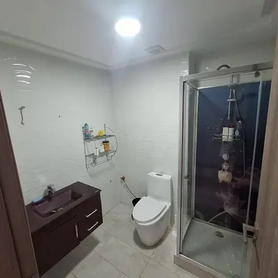 a bathroom with a shower and a toilet and a sink at Appartement à 10min de la mer in Mansouria
