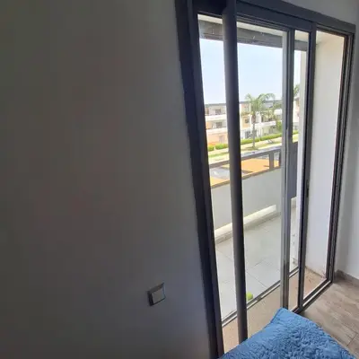 a door to a room with a view of a balcony at Appartement à 10min de la mer in Mansouria