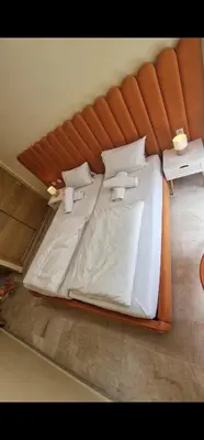 a large bed with white sheets and pillows at 2Roms 5mn Palmier Maarif Distriktet Wifi Rapide A4 in Casablanca
