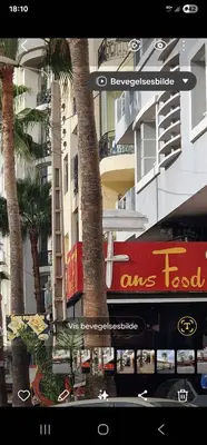 a sign for a fast food restaurant next to a building at 2Roms 5mn Palmier Maarif Distriktet Wifi Rapide A4 in Casablanca