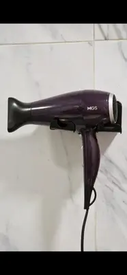 a hair dryer is hanging on a wall at 2Roms 5mn Palmier Maarif Distriktet Wifi Rapide A4 in Casablanca