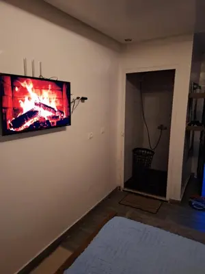 a living room with a flat screen tv on the wall at La Pause Dar Bouazza in Tamaris