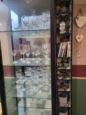 a glass cabinet filled with lots of wine glasses at Spacious and convenient in Casablanca