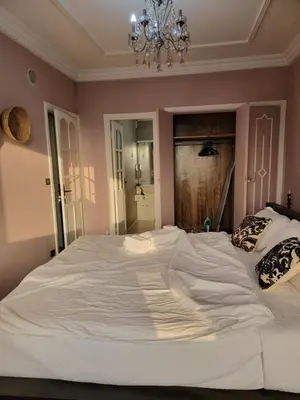 a large white bed in a bedroom with a chandelier at Spacious and convenient in Casablanca