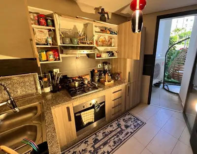 a kitchen with a stove and a sink at Logement 5 etoiles avec piscine et jardin privée à rabat hay riad in Rabat