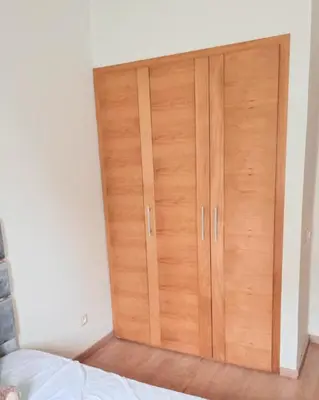 a large wooden cabinet in a room with a bed at Perfect Family Apartment in Tamaris