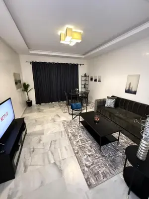 a living room with a couch and a table at Charmant Appart 5 minutes de La Plage Sablette in Mohammedia