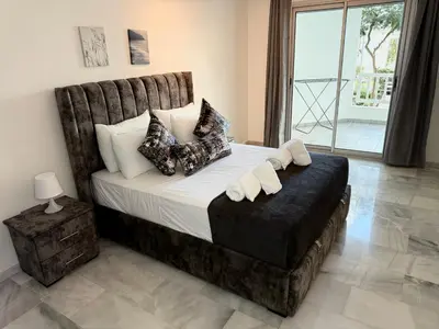a bedroom with a large bed with pillows at Charmant Appart 5 minutes de La Plage Sablette in Mohammedia