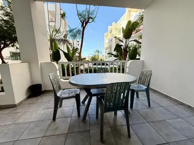 a table and chairs on a balcony with a table and chairs at Charmant Appart 5 minutes de La Plage Sablette in Mohammedia