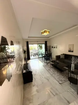 a living room with a couch and a table at Charmant Appart 5 minutes de La Plage Sablette in Mohammedia