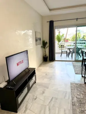 a living room with a television on a table at Charmant Appart 5 minutes de La Plage Sablette in Mohammedia