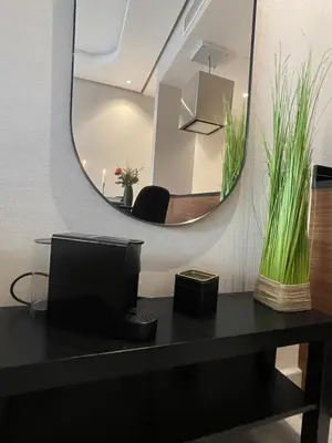 a mirror sitting on top of a table with a television at A 1 pas de Zara Magnifique Studio Premium in Casablanca
