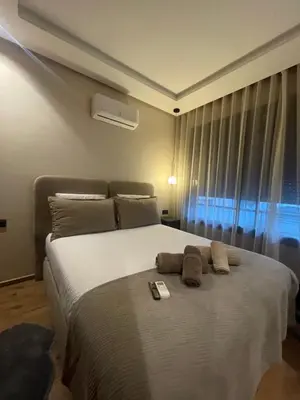 a bedroom with a large white bed with a window at A 1 pas de Zara Magnifique Studio Premium in Casablanca