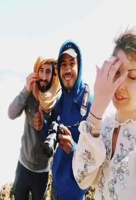 a group of three people posing for a picture at KHaIMA