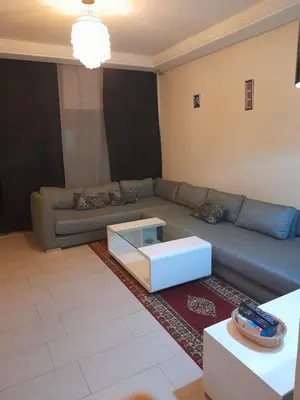 a living room with a couch and a coffee table at La cascade 2 in Sidi Rahal