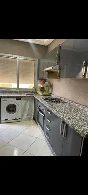 a kitchen with a sink and a stove top oven at Sidi rahal apartment in Sidi Rahal