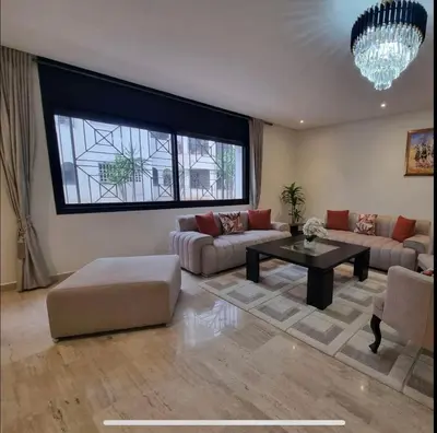 a living room with a couch and a table at Modern gated apartment 2 bedroom 2 baths Beachside with pool in Casablanca