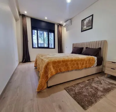 a bedroom with a large bed and a window at Modern gated apartment 2 bedroom 2 baths Beachside with pool in Casablanca