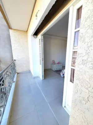 an open door to a balcony of a house at villa dans el mansouria in Mansouria