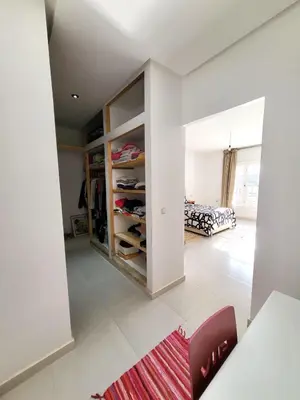 a living room with a walk in closet at villa dans el mansouria in Mansouria