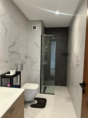 a bathroom with a toilet and a glass shower at Business Travel - Luxury 1 BD Flat - Casablanca Finance City in Casablanca