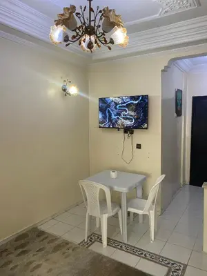 a dining room with a white table and chairs at Chez Baye in Casablanca