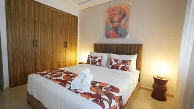 a bedroom with a bed and a painting on the wall at Central Quiet Spot in Casablanca