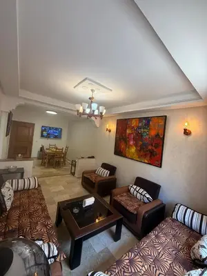 a large living room with couches and a table at Appartement 3 pièces à Mohammédia Proche Marjane, plage & restaurants in Mohammedia