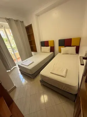 a bedroom with two beds and a window at Appartement 3 pièces à Mohammédia Proche Marjane, plage & restaurants in Mohammedia