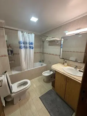 a bathroom with a toilet and a sink and a tub at Appartement 3 pièces à Mohammédia Proche Marjane, plage & restaurants in Mohammedia