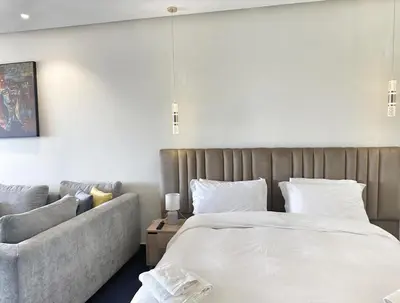 a bedroom with a large bed and a couch at 1-Marina Luma oceane-terrasse sur mer in Casablanca