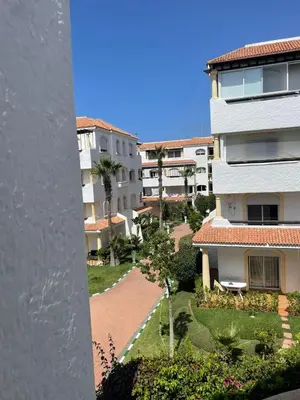 an aerial view of a building with palm trees at Garden Beach 2 in Sidi Rahal