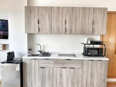a kitchen with a sink and a microwave at 3-marina Serena ocean-studio chic vue mer in Casablanca