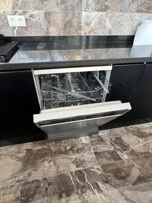 a dishwasher with its door open in a kitchen at Apartment with pool view in Mansouria