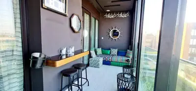 a bar with stools in a room with a window at The Bleu waves in Casablanca