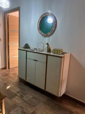 a room with a counter with a mirror on the wall at Cozy apartment near the airport in Deroua