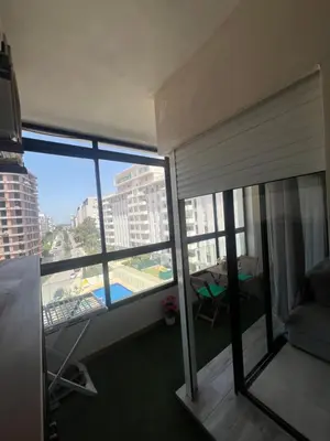 a room with a balcony with a view of a building at Appartement Élégance Cosy in Rabat