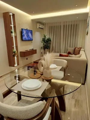 a living room with a glass table and a couch at Studio à louer CFC in Casablanca