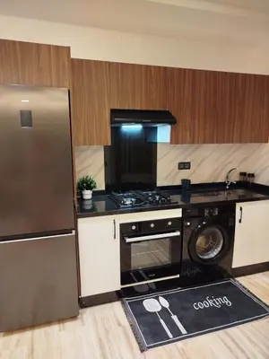 a kitchen with a stainless steel refrigerator and a dishwasher at Studio à louer CFC in Casablanca