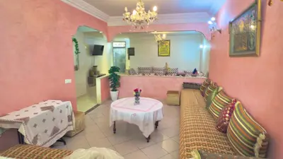 a room with a table and two couches and a table and chairs at Immense appartement familial vue sur mer in Rabat