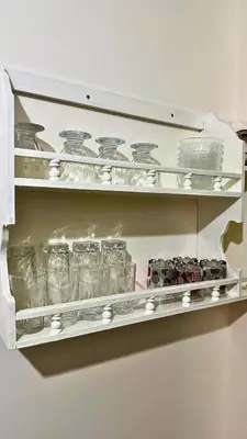 a shelf filled with glasses and other glass items at Cozy Apartment Near Rabat & Beach in Temara
