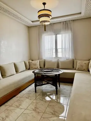 a living room with a couch and a table at An Elegant apartment, Quiet Stay with Moroccan Touch in Dar Bouazza