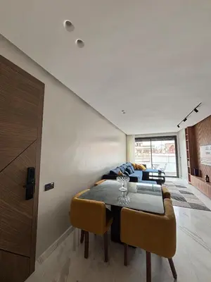 a dining room with a table and a couch at Premium Apt Casa City Center in Casablanca