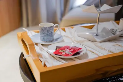 a tray with a cup and a plate on a bed at Exclusive Apt Casa City Center in Casablanca