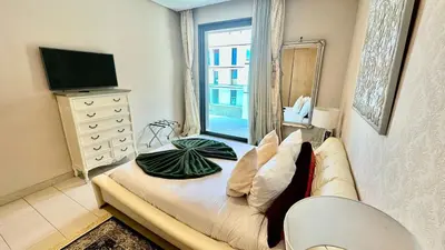a bedroom with a couch and a tv and a window at 2 Bedroom Apartment in Casablanca