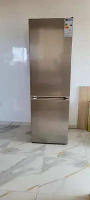 a stainless steel refrigerator sitting in a room at Perle Bouznika in Bouznika