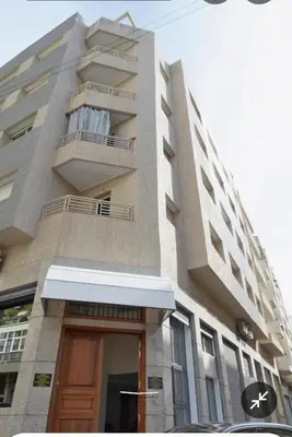 a tall building with a door and a balcony at Appartement cosy près Abdelmoumen Maarif in Casablanca