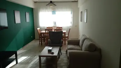 a living room with a couch and a table at Appartement cosy près Abdelmoumen Maarif in Casablanca