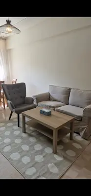 a living room with a couch and a coffee table at Appartement cosy près Abdelmoumen Maarif in Casablanca