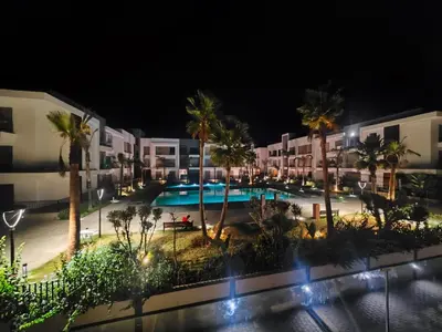 an aerial view of a resort at night at Luxury apartment in Oulad Mbark
